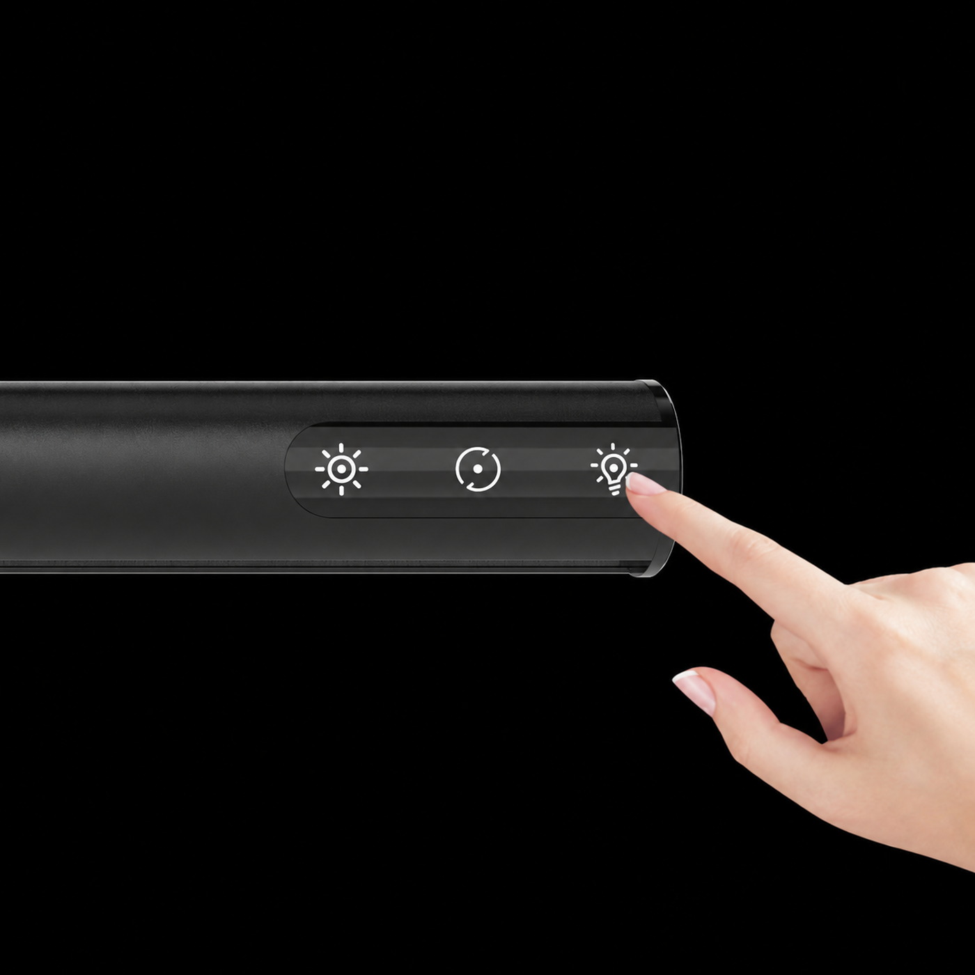 A hand touching the control panel on a black LumenBar monitor light